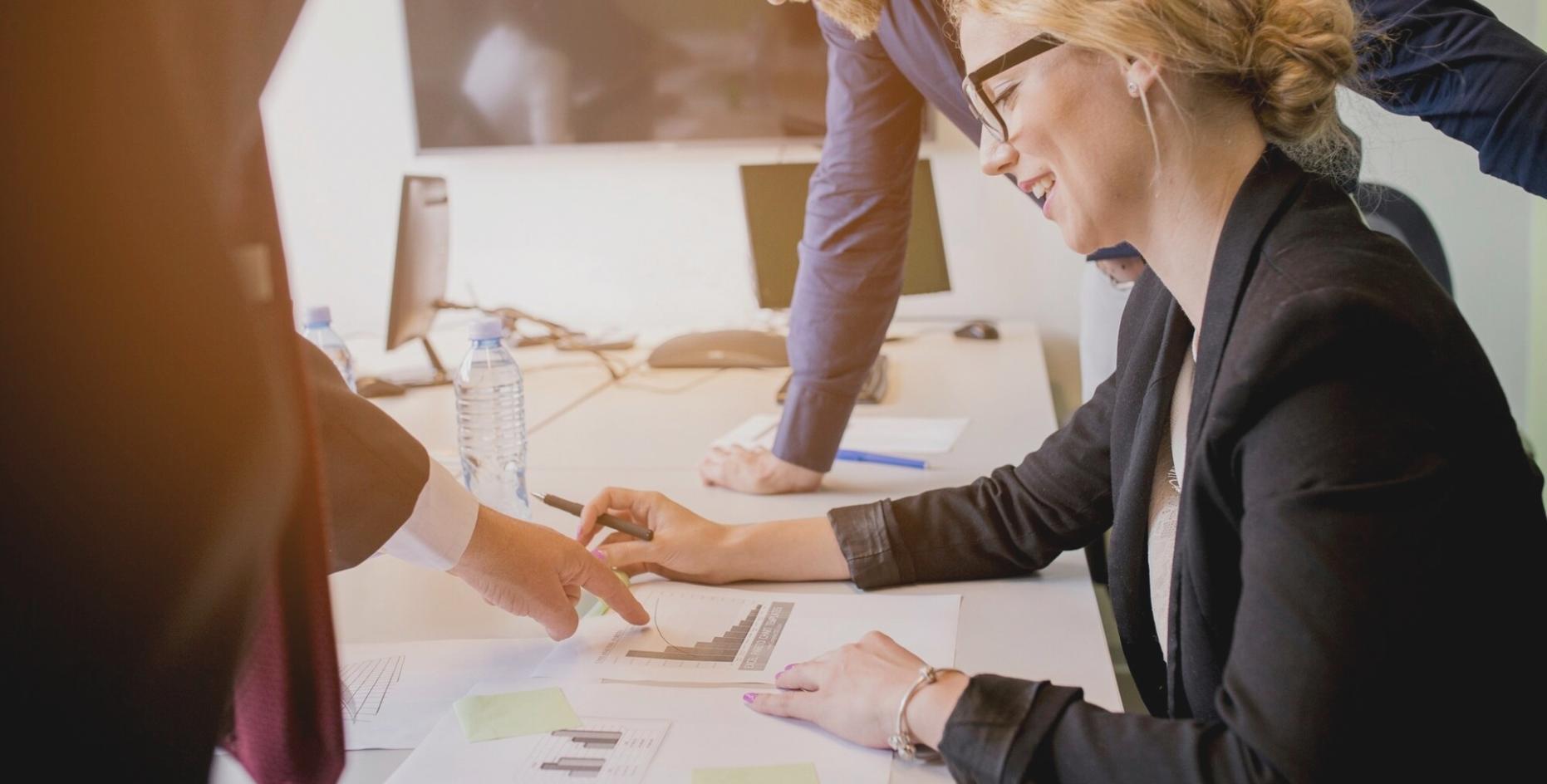 Professional financial consultation workspace with analysis documents and planning materials
